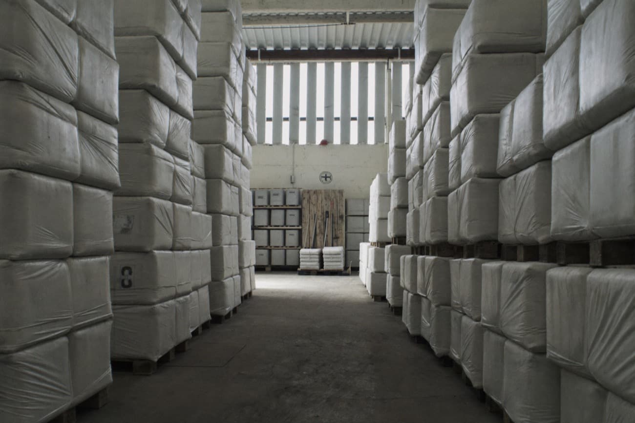 Warehouse aisle with stacked wrapped pallets — agricultural commodity storage and customs clearance operations